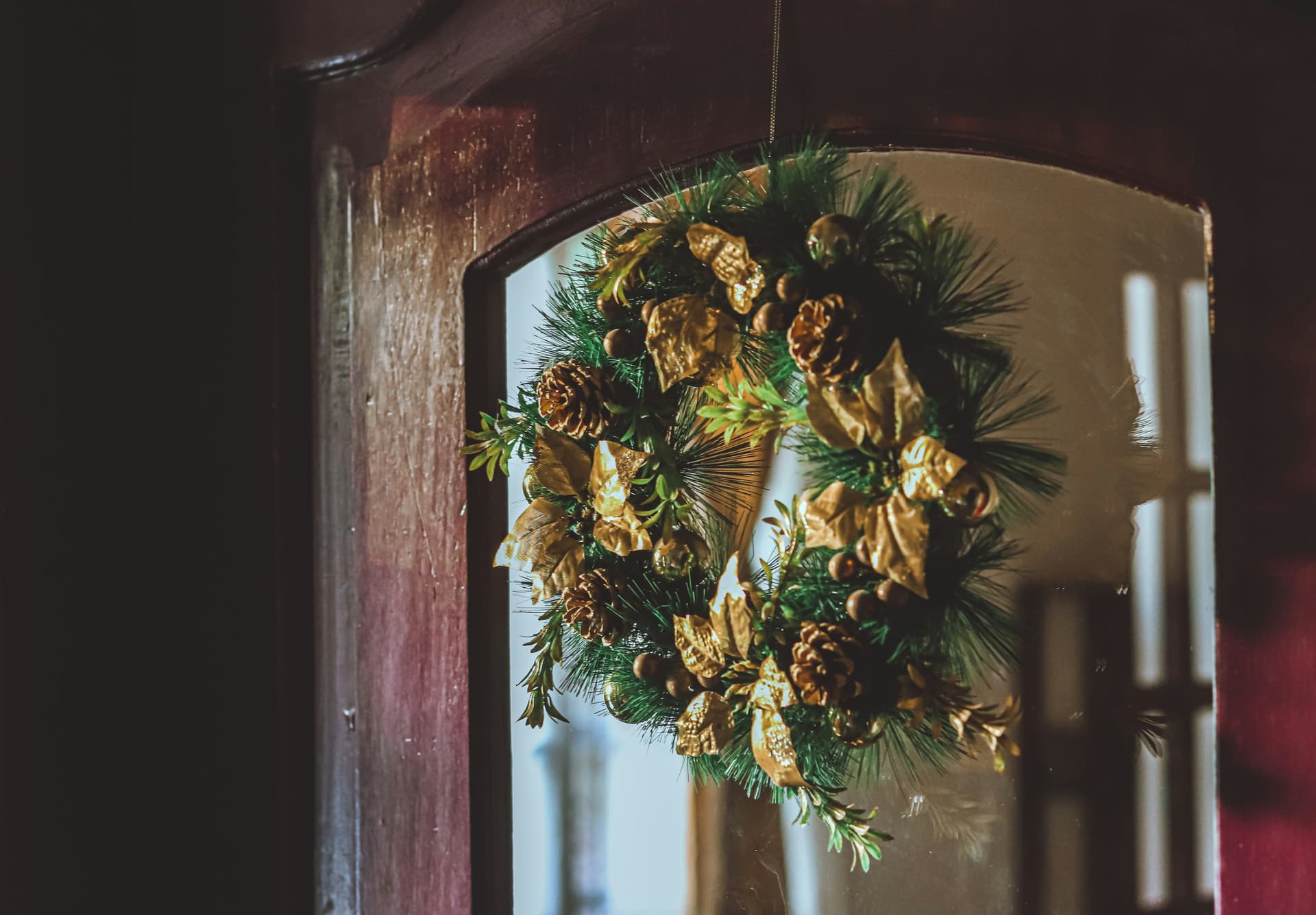 green and brown wreath on brown wooden door