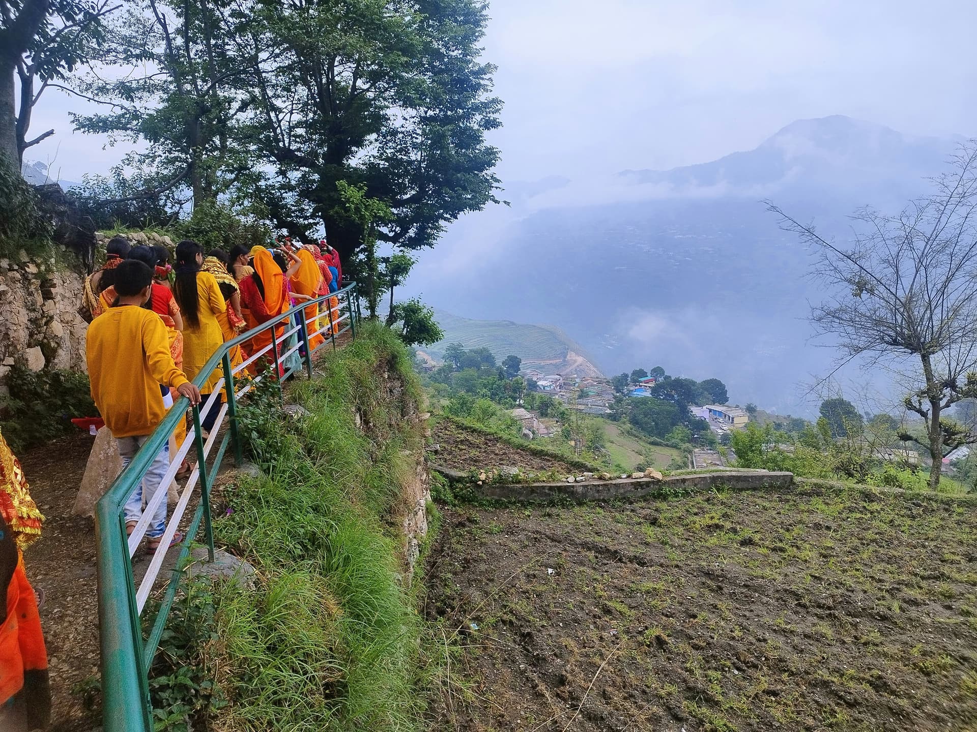 A long line of people walking up a hill