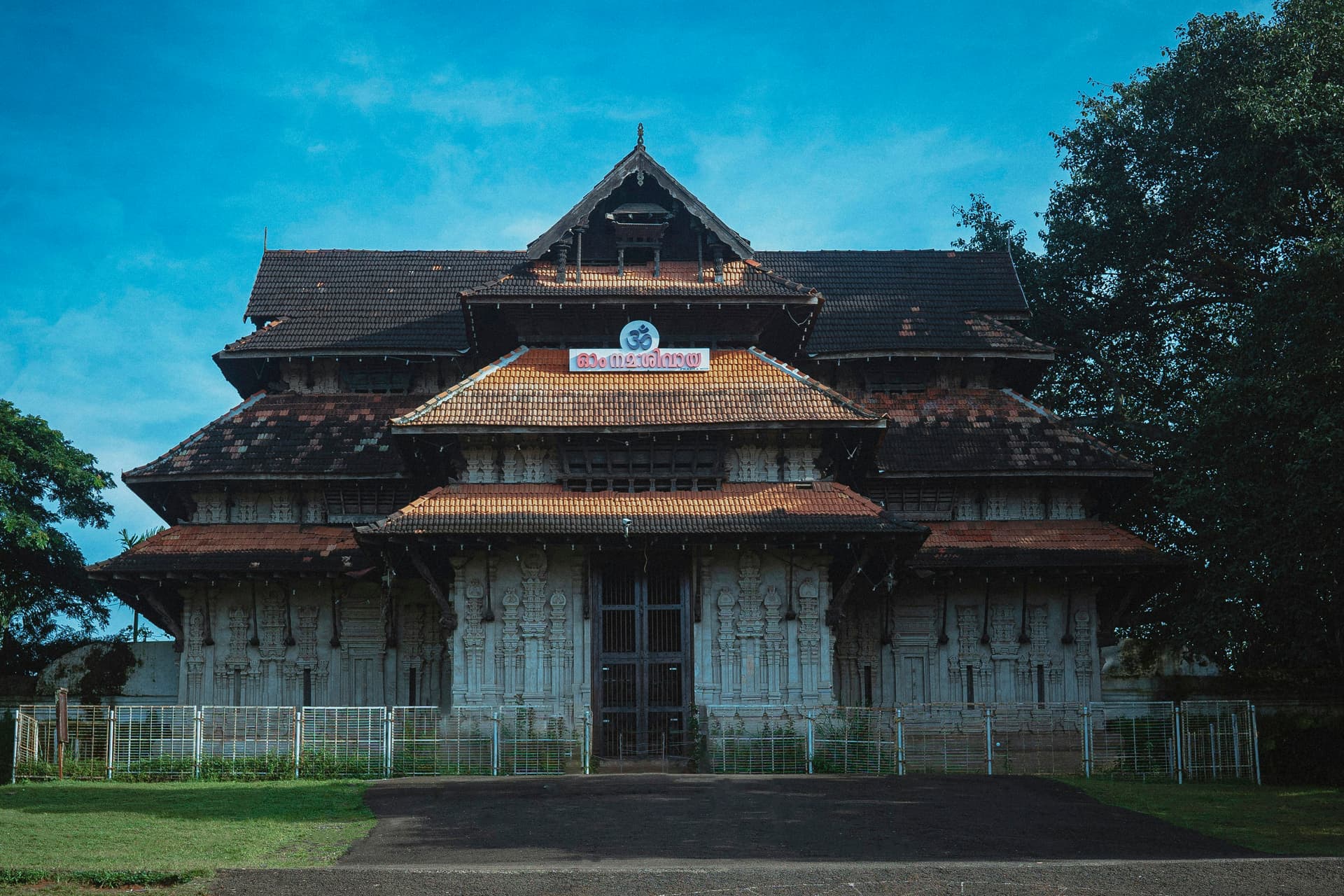 A large wooden building with a fence around it